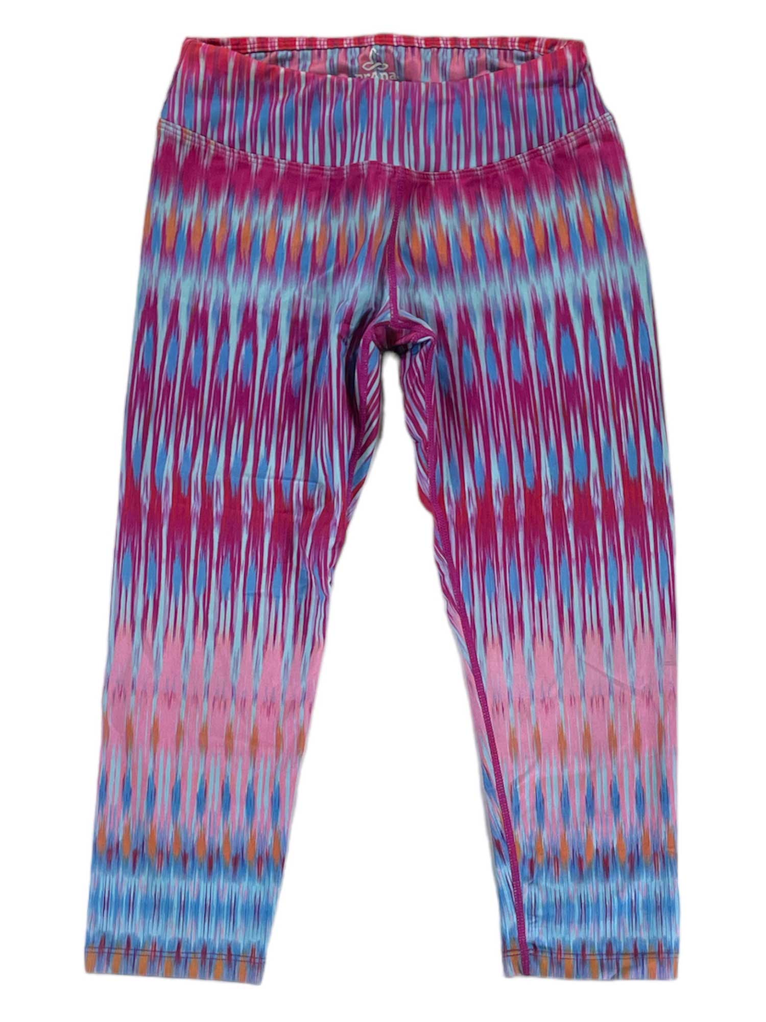 Womens Roxanne Capris featuring a vibrant ikat print in pink, blue, purple, and orange on micropoly performance jersey. Designed for yoga, shown flat on a white background.