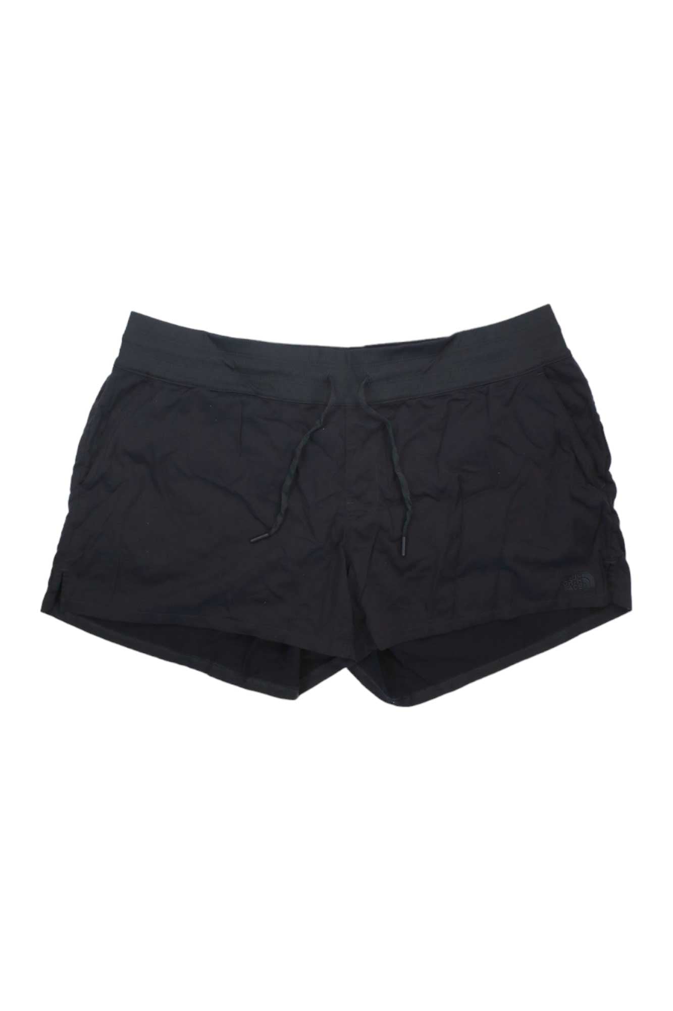 A pair of Women's Aphrodite Motion Shorts in black, featuring an elastic waistband and drawstring, are displayed flat on a white background.