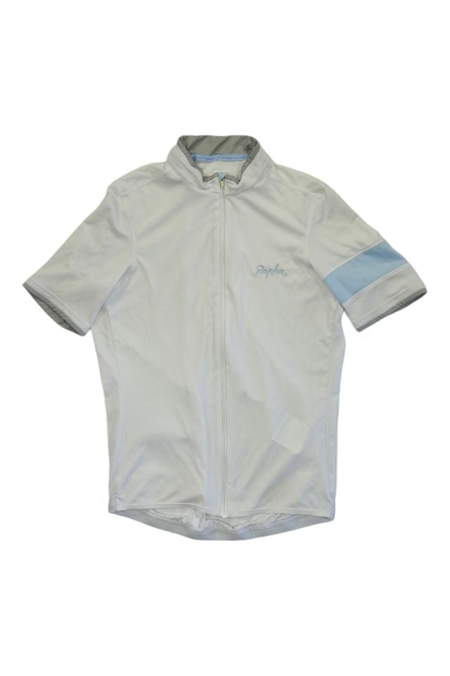 The Rapha Men's Super Lightweight Jersey is a light gray, short-sleeve cycling jersey featuring a full front zipper, high collar with gray trim, subtle chest branding, and a light blue stripe on the left sleeve.