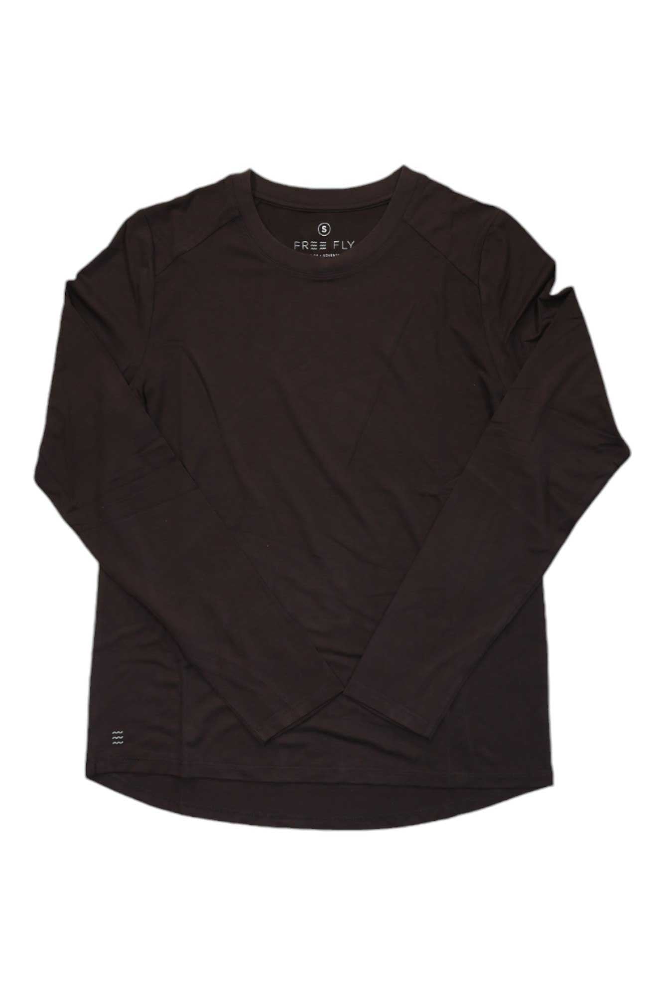 The Free Fly Womens Bamboo Shade LS II Top, a minimalist black long-sleeve crew neck shirt, is laid flat on a white background with the sleeves slightly crossed. This UPF 50+ top offers sun protection in a classic, simple style.
