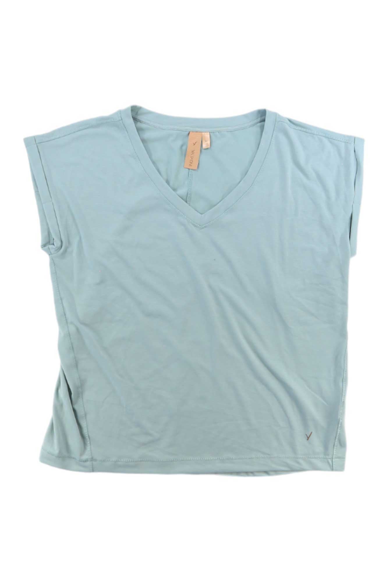 The Indyeva Womens Sofi Top is a light blue short-sleeve V-neck shirt with a beige neckline tag and small embroidered logo near the hem, offering sun protection and comfort for hiking or outdoor adventures.