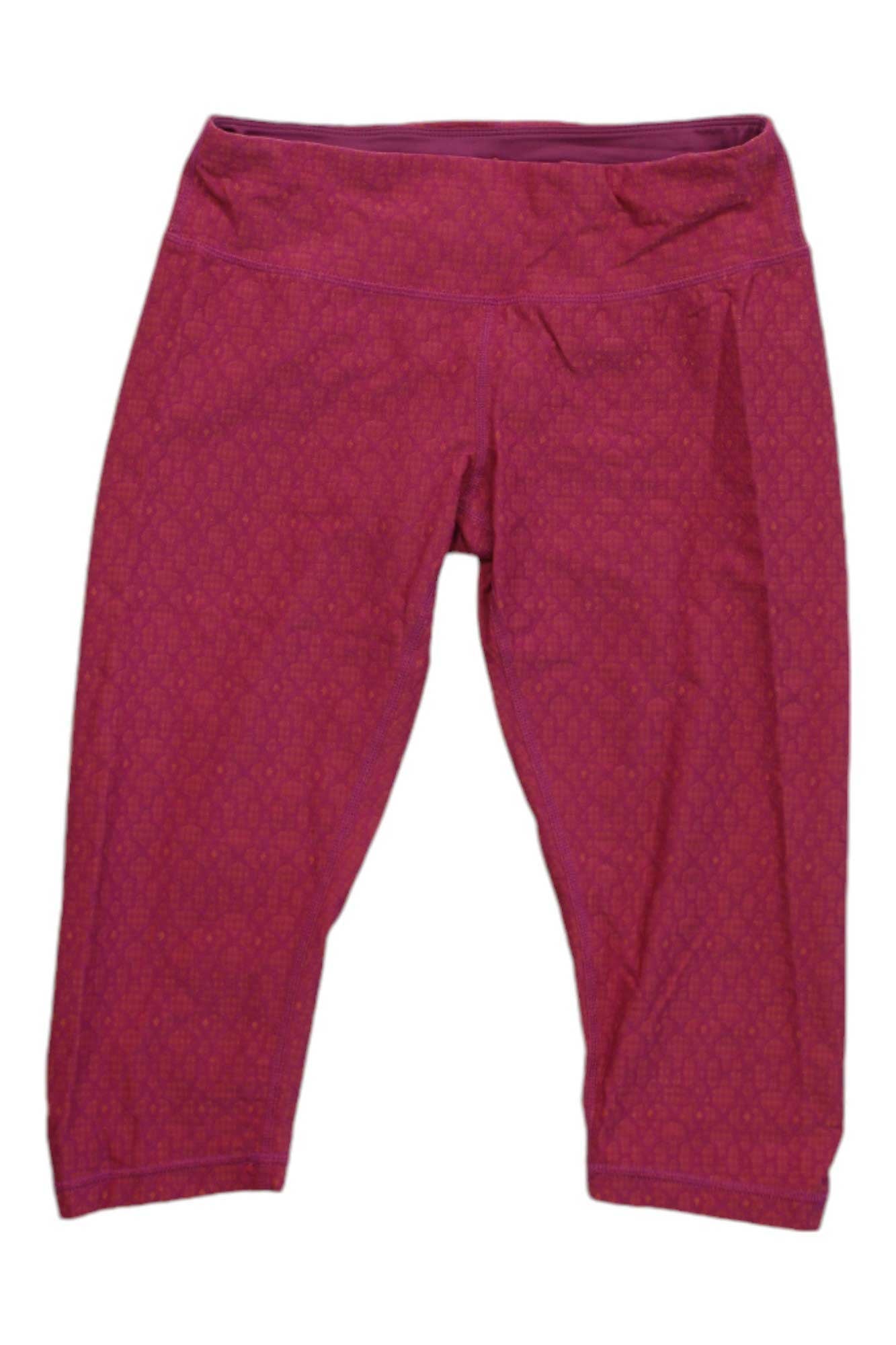 Prana Womens Misty Knickers in bright pink, cropped activewear leggings with moisture-wicking fabric and a wide waistband, shown laid flat on a white background.
