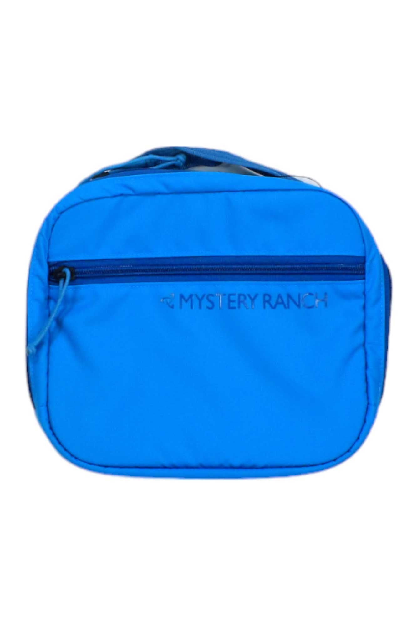 The Mystery Ranch Mission Control Case is a bright blue travel pack with a front zippered pocket and the brand name on the front—ideal for use as a carry-on bag for your next trip.
