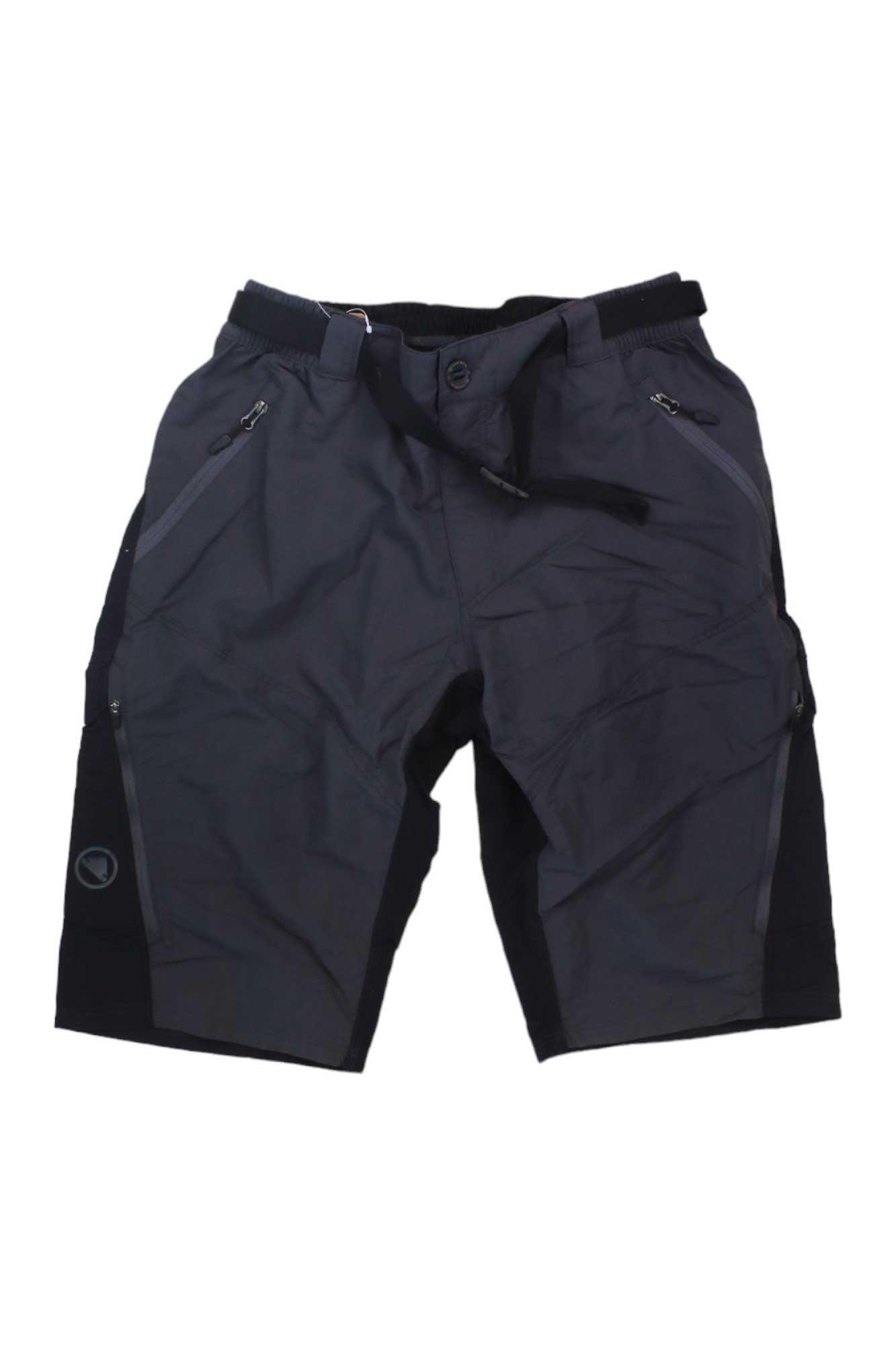 The Endura Men's Hummvee Short with Liner is a dark gray and black, knee-length short featuring zippered and cargo pockets, a button closure, and an adjustable belt, shown on a white background.