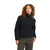 A woman with curly hair wears The North Face Womens Cragmont Fleece Jacket over olive green pants, standing against a plain white background with a neutral expression.