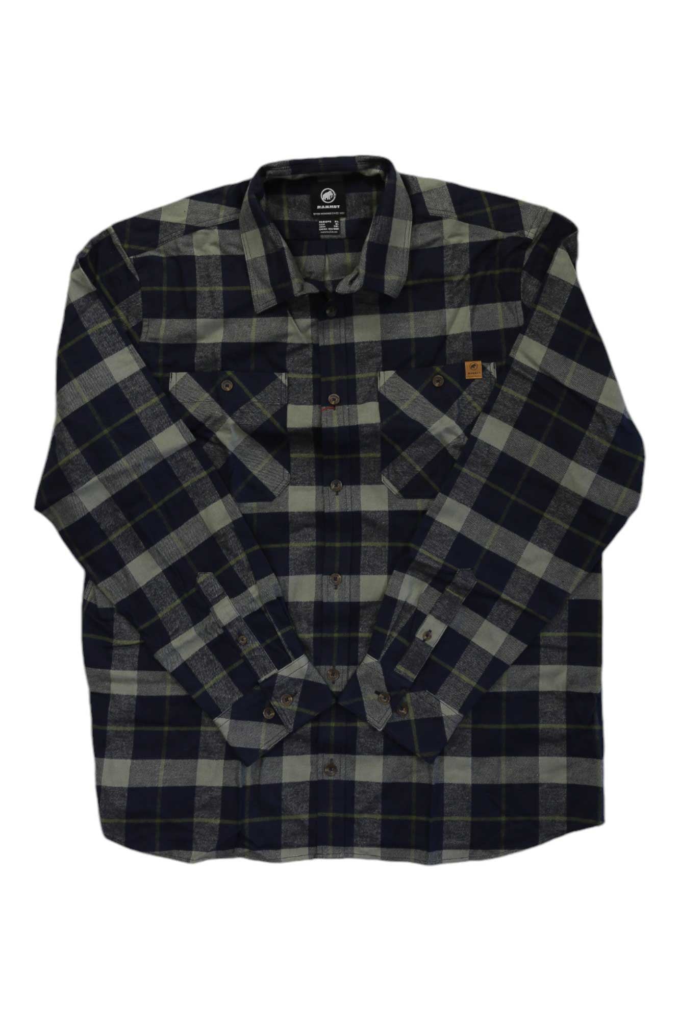The Mammut Mens Alvra LS Shirt is a long sleeve button-up in black, gray, and green plaid with two chest pockets, brown buttons, and a tan logo patch—an ideal organic cotton choice for men’s hiking adventures.