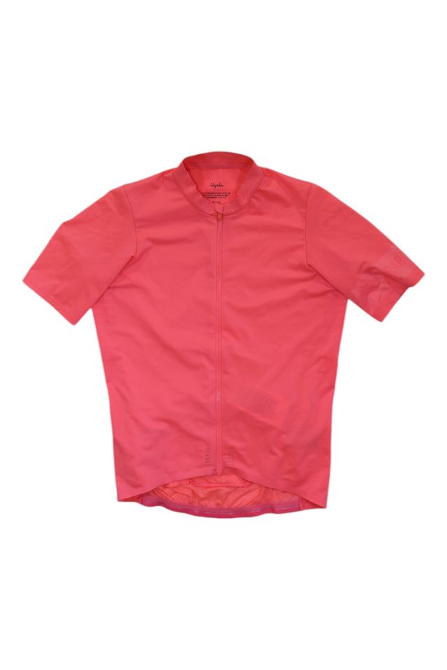 A men's Pro Team Midweight Short Sleeve Jersey in bright pink, featuring short sleeves, front zipper, fitted cut, and slightly longer back hem, is displayed against a white background.
