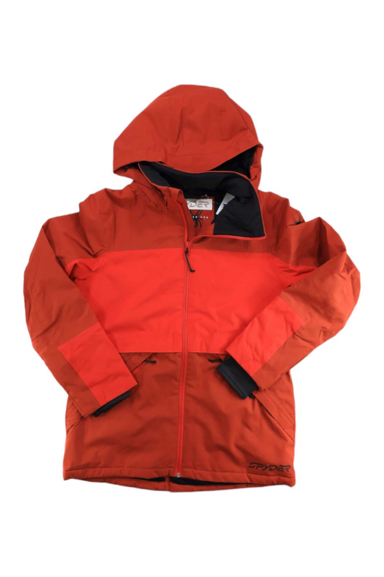 The Spyder Women's Field Jacket is a red insulated ski jacket with a hood, front zipper, black lining, long sleeves, and Spyder branding on the bottom hem. This waterproof jacket is displayed flat on a white background.