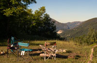 camping chairs around a campfire