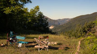 camping chairs around a campfire