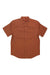 The Topo Designs Mens Dirt SS Shirt is a short-sleeved, button-up organic cotton shirt in solid rust brown with a front chest pocket, shown flat on a white background.