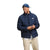A man wearing The North Face Men's Big Aconcagua 3 Jacket in navy blue, a white shirt, beige pants, and a blue cap smiles while looking down against a plain white background.