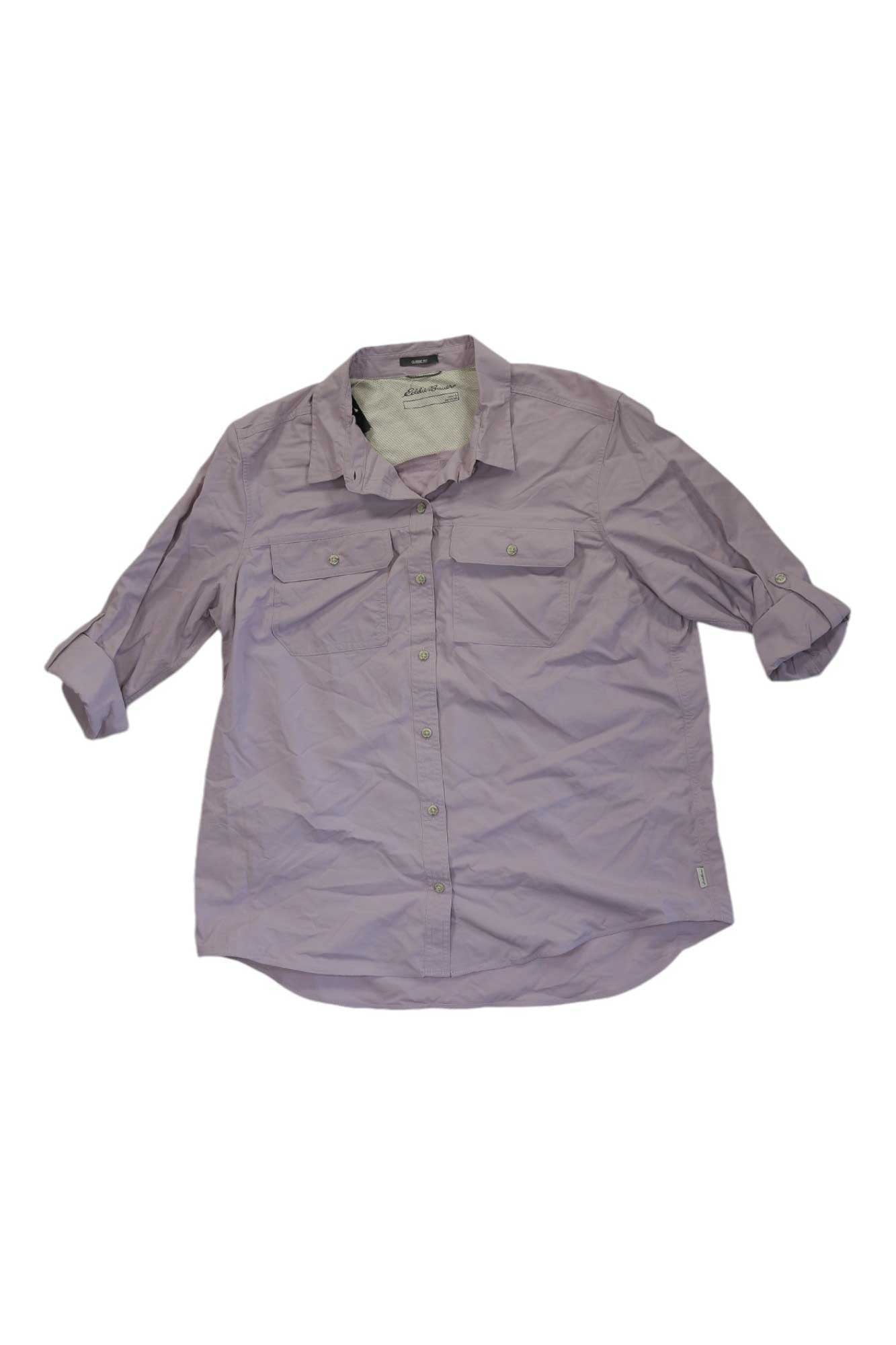 The Eddie Bauer Women's Mountain Ripstop LS Shirt in light purple features long sleeves with rolled cuffs and two chest pockets, displayed flat on a white background.
