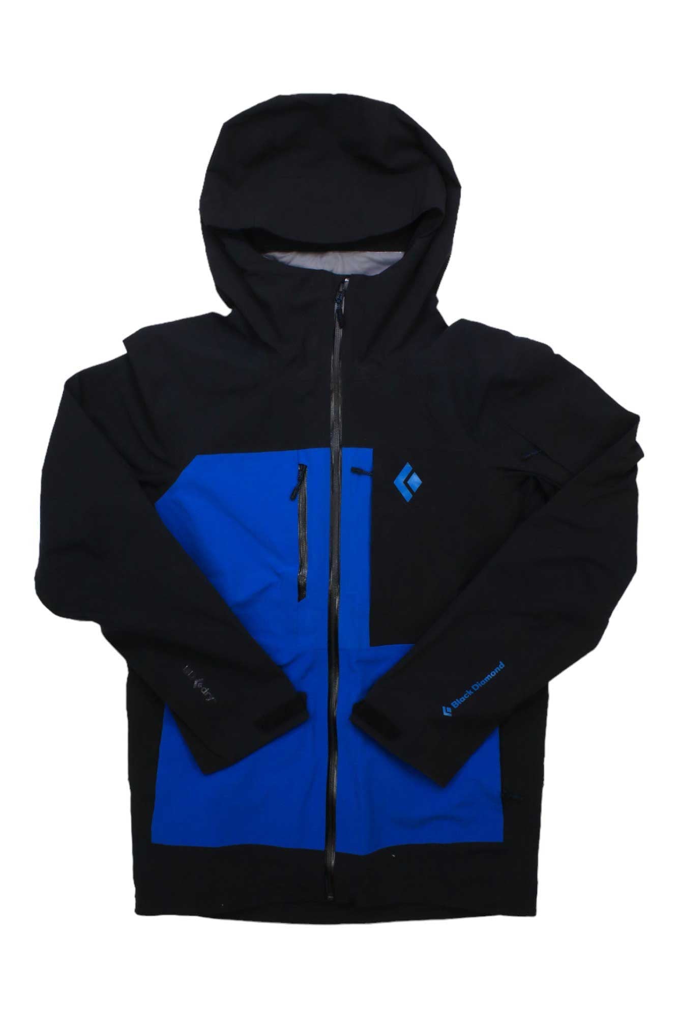 The Black Diamond Men's Recon Stretch Pro Shell Jacket is a black and blue waterproof shell with a front zipper, chest pocket, logo on the chest and left sleeve, snow helmet compatible, shown on a white background.