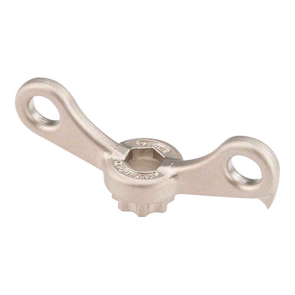 The Park Tool BBT-10.2 Crank Adjusting Cap Tool features a silver metal wingnut with two flat, rounded wings and a central hexagonal hole, perfect for hand tightening or loosening during bike maintenance.