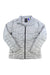 The Burton Womens AK Baker Down Jacket in light gray features a quilted design, front zipper, two side pockets, and a high collar—an ideal packable layer for backcountry gear, shown flat on a white background.