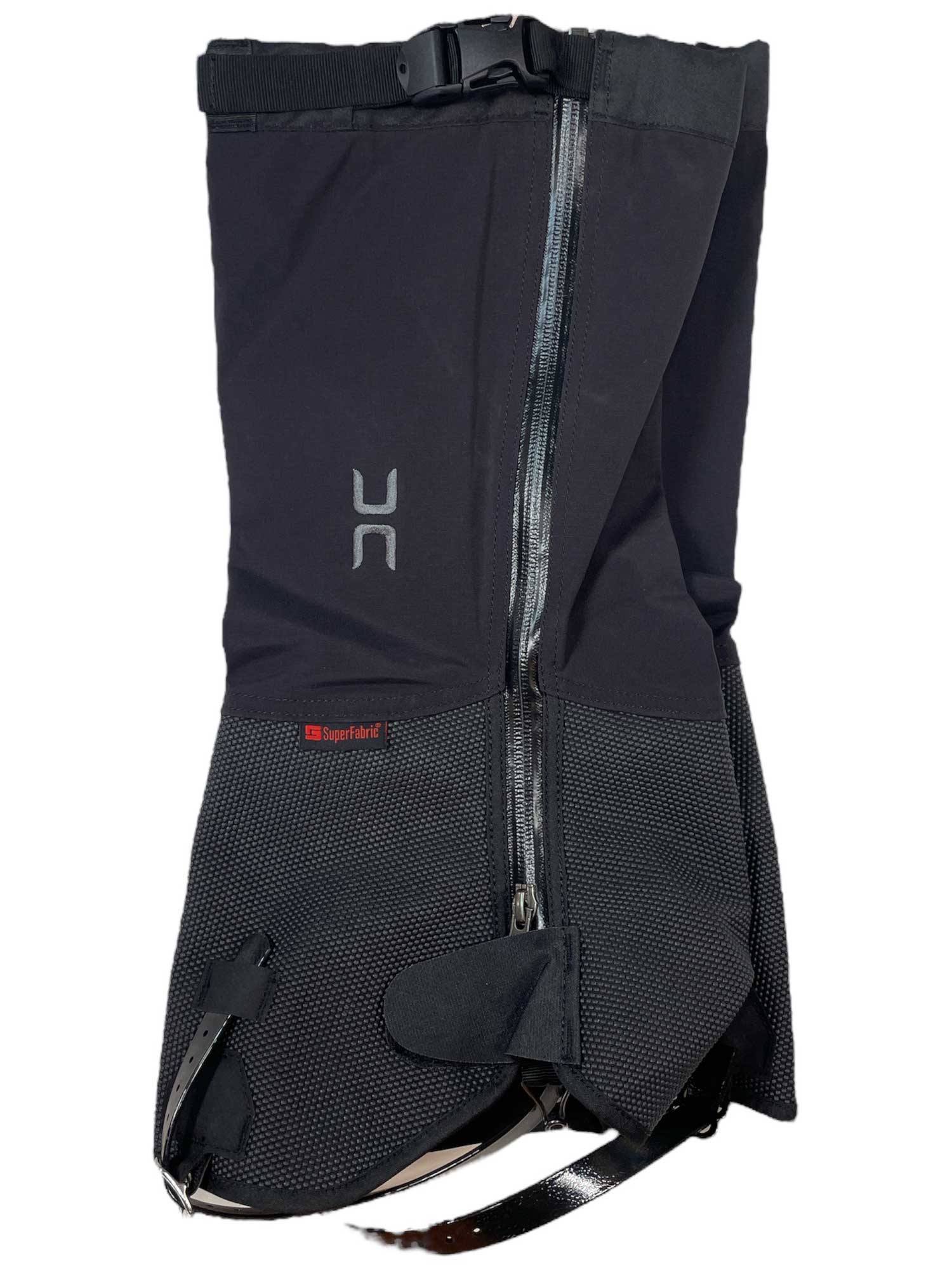 The Hillsound Super Armadillo Gaiter is a black gaiter with a front zipper, adjustable top buckle, mesh lower section, boot strap, and small red Superfabric® label—ideal for mountaineering gear.