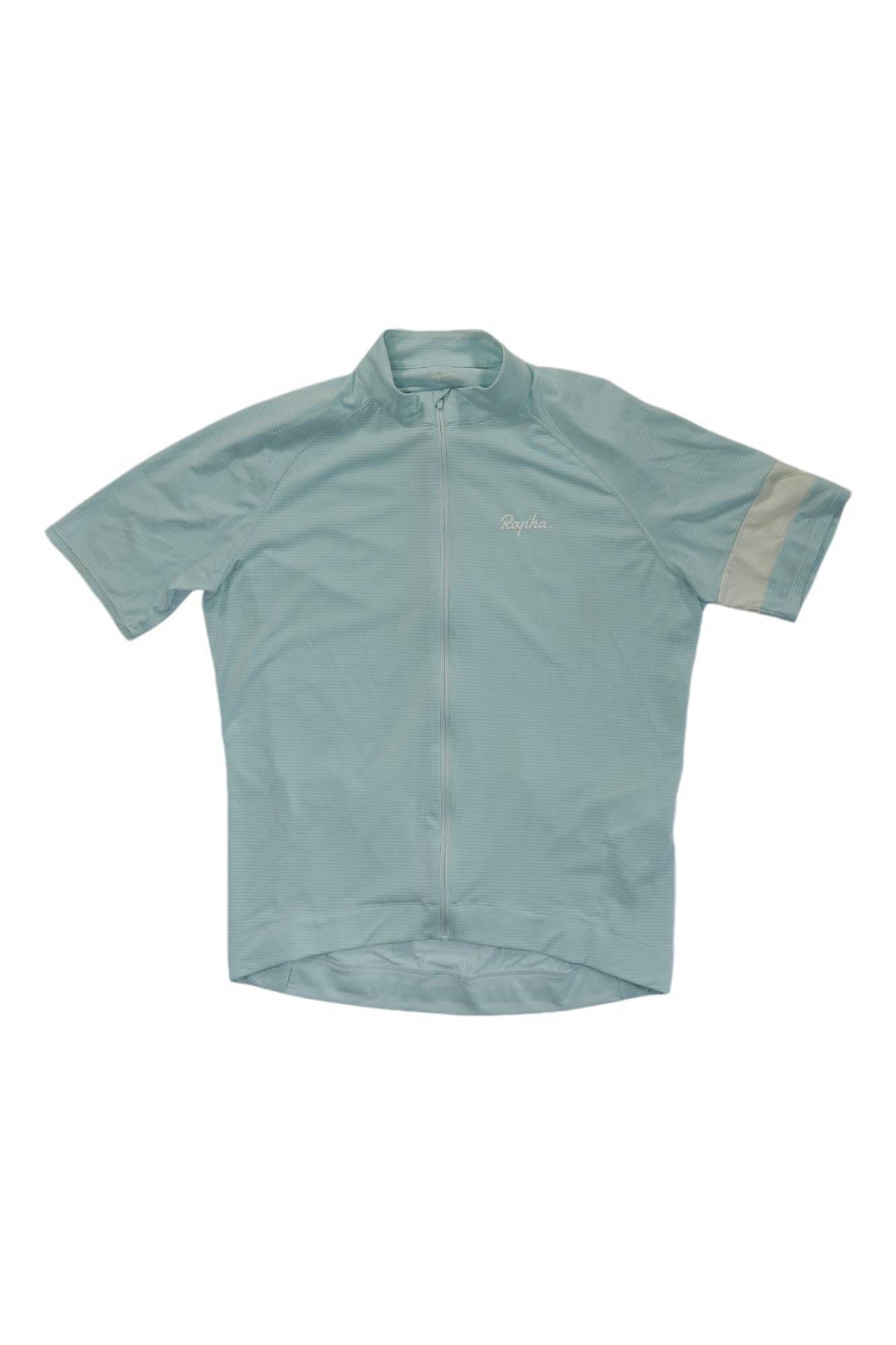 The Rapha Mens Core Lightweight Jersey in light blue features short sleeves, a full front zipper, and a horizontal stripe on the left sleeve. Lightweight and breathable, it's ideal for warm-weather rides. Displayed on a plain white background.