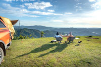 couple sitting on a hilltop in the countryside