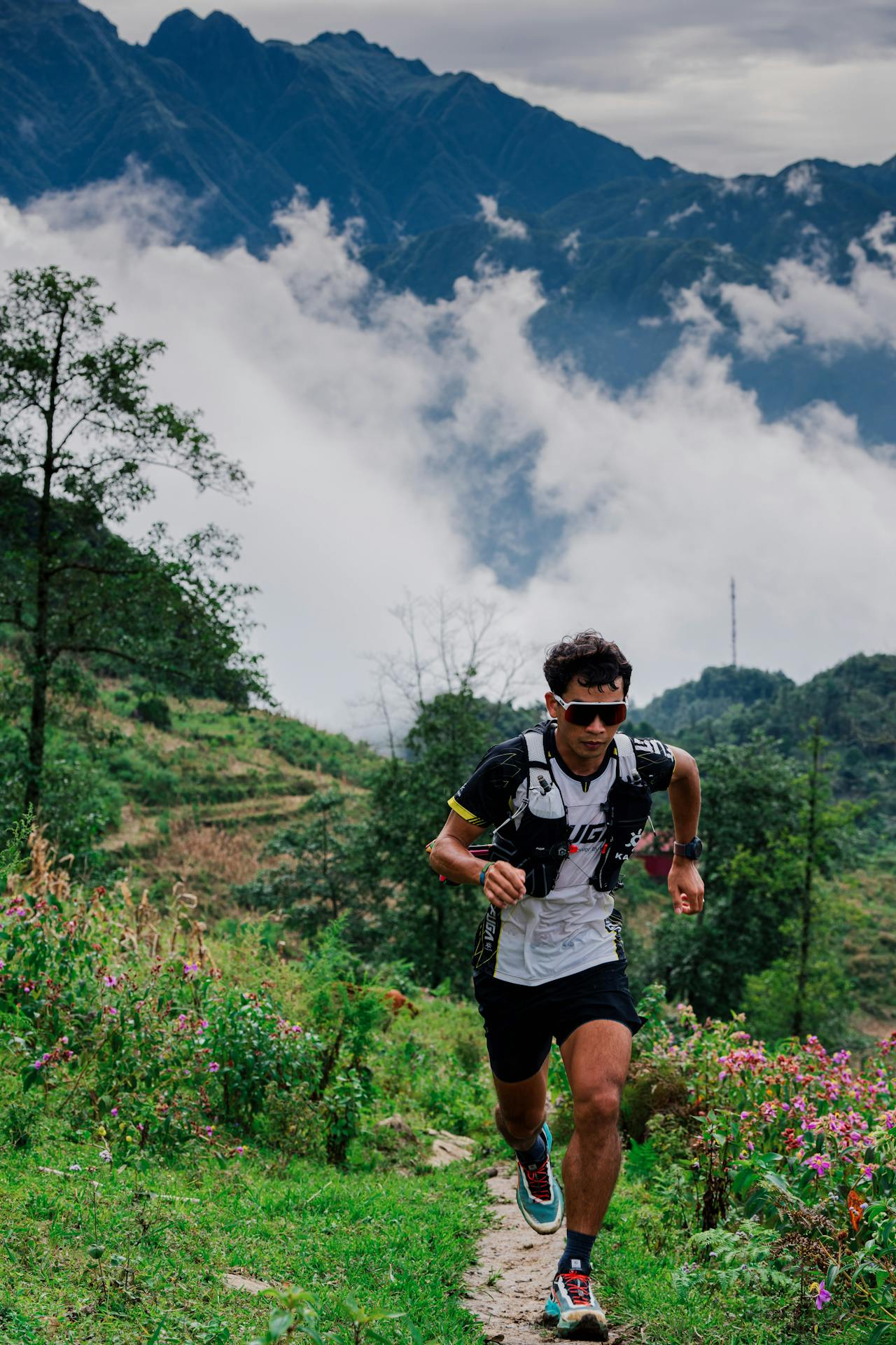 A person running on a trail in the mountains