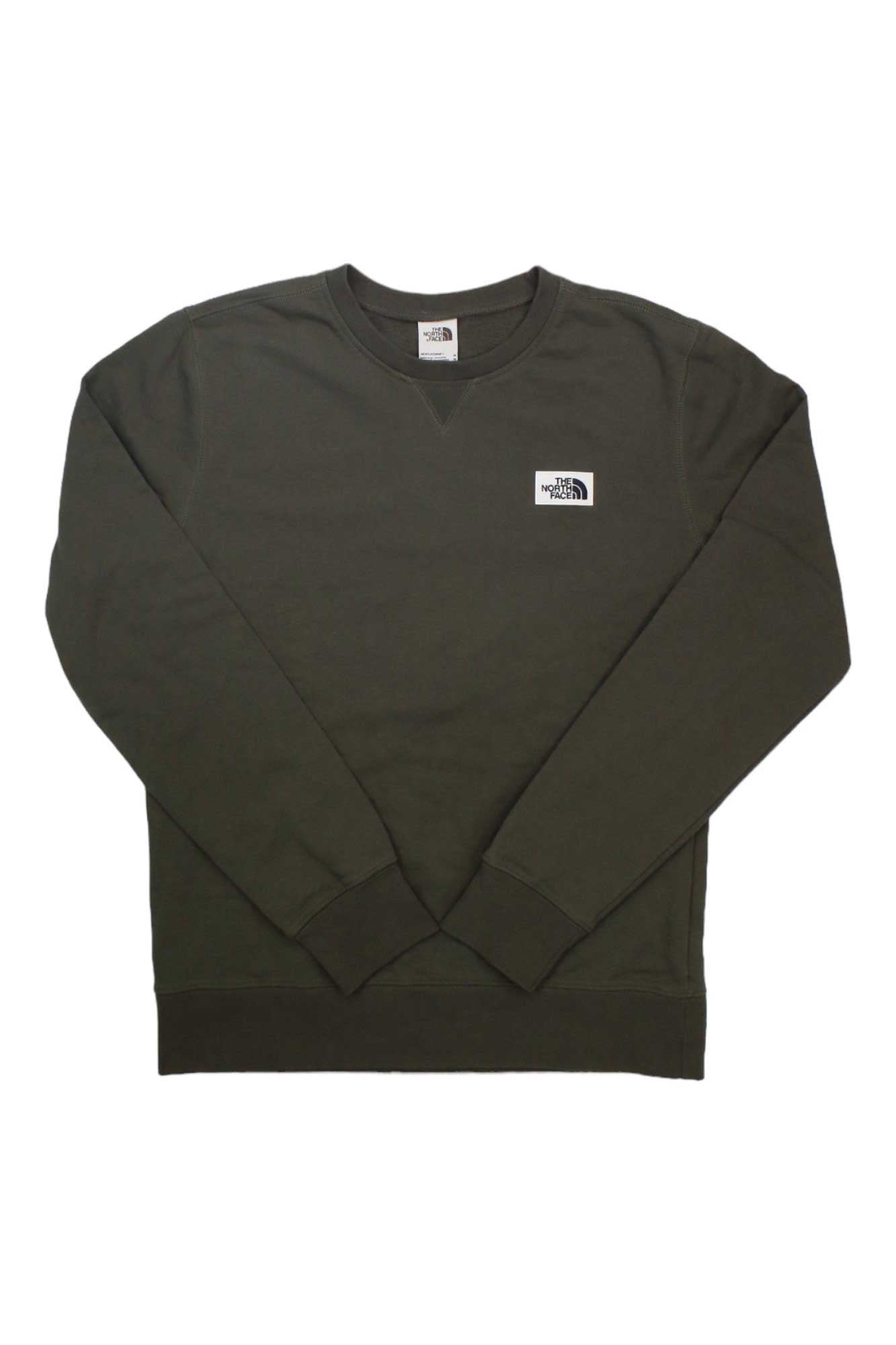 The North Face Mens Heritage Patch Crew is an olive green sweatshirt with long sleeves, ribbed cuffs, and a logo patch on the left chest—perfect for daily comfort and classic style.