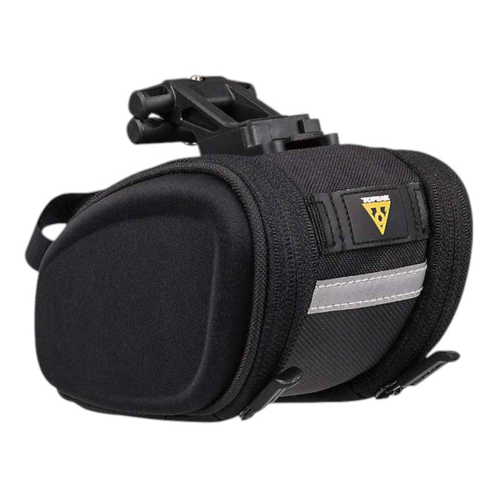 The Topeak SideKicks STW Wedge Pack is a black, compact under-saddle bike bag with a hard shell, reflective strip, mounting clip on top, and the Topeak logo on the front flap—ideal for cycling storage.