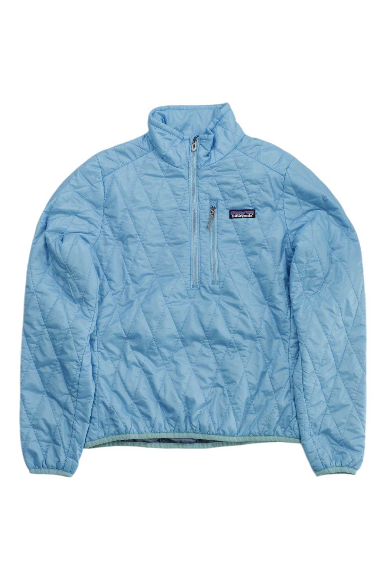 The Women's Nano Puff Insulated Pullover from Patagonia is a light blue, lightweight jacket featuring a quilted design, half-zip front, long sleeves, and a left chest pocket with the rectangular Patagonia logo patch.