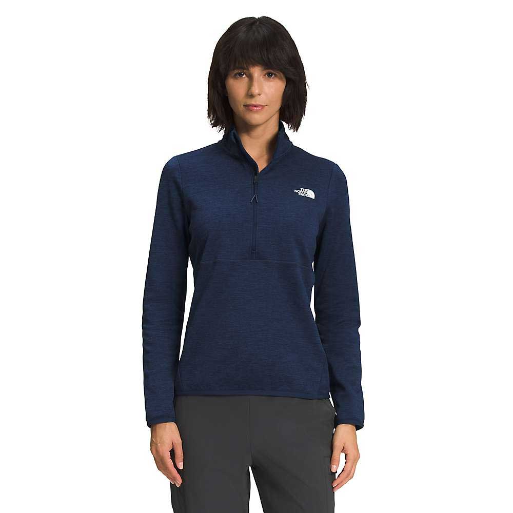 A woman faces forward in a navy blue The North Face Womens Canyonlands 1/4 Zip Top and dark pants, standing against a plain white background.