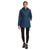 A woman wears The North Face Womens ThermoBall Eco Parka in blue, made from recycled nylon, paired with black leggings and black athletic shoes. She stands facing forward with one hand in her pocket against a white background.