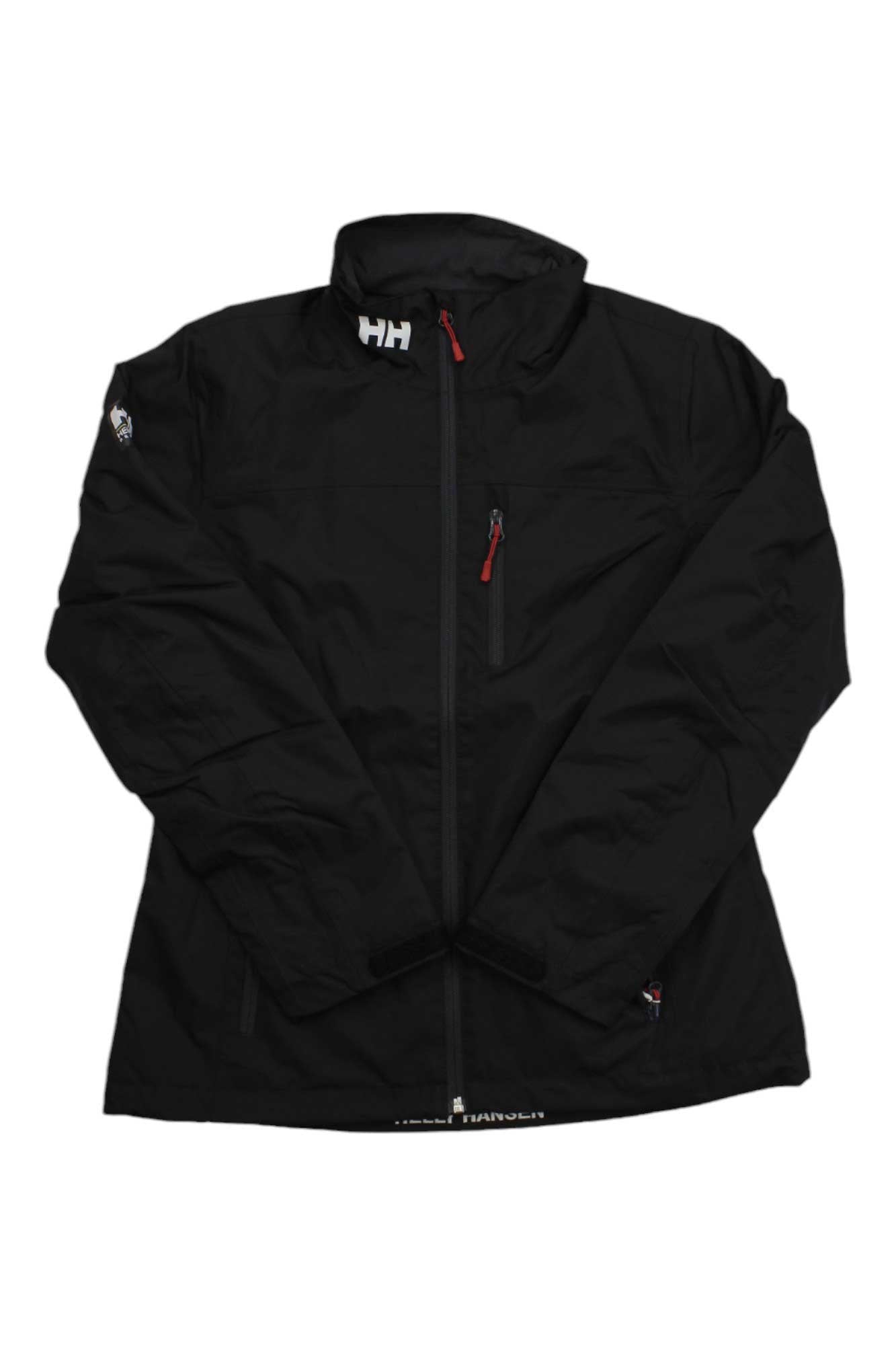The Helly Hansen Womens Crew Midlayer Jacket is a black, waterproof jacket with long sleeves, a front zipper, a chest pocket with a red zipper, and the HH logo on the collar. It features a simple and functional design.