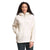 A woman with long curly hair wears the Womens Ridge Fleece Tunic, a cream-colored sherpa pullover with a quarter zip and front pocket, standing against a plain white background.