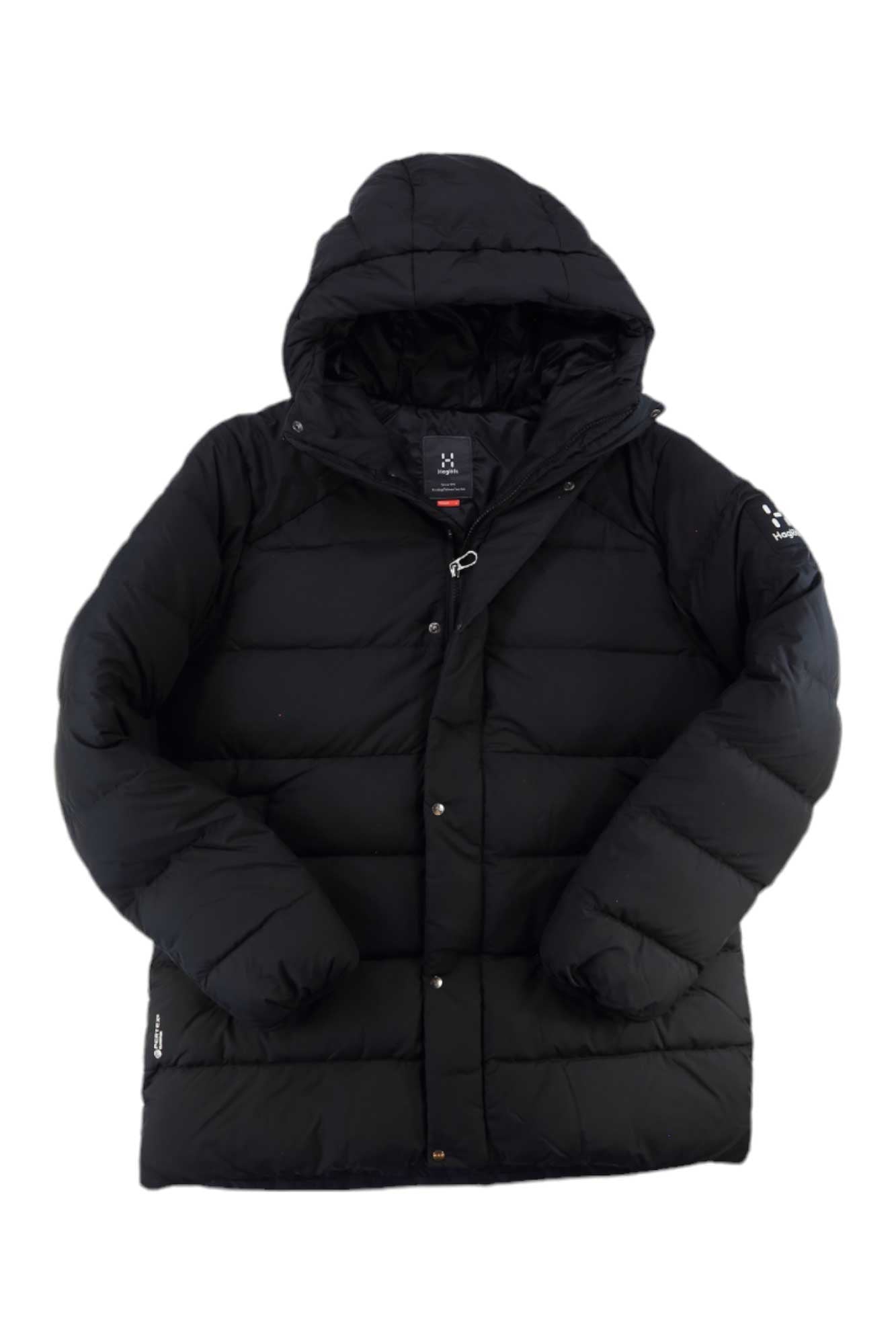 The Haglofs Womens Nas Down Jacket is black with a hood, front snap buttons, a small logo on the upper left sleeve, and made from recycled polyester for water-resistant protection. Displayed on a white background.