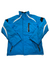 A blue Stratton Jacket with white and black accents, front zipper, zippered chest pocket, high collar, and insulation is laid flat on a white background.