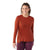 A woman with curly hair, wearing the Smartwool Womens Active LS Crew Top in rust and maroon leggings, smiles against a white background.
