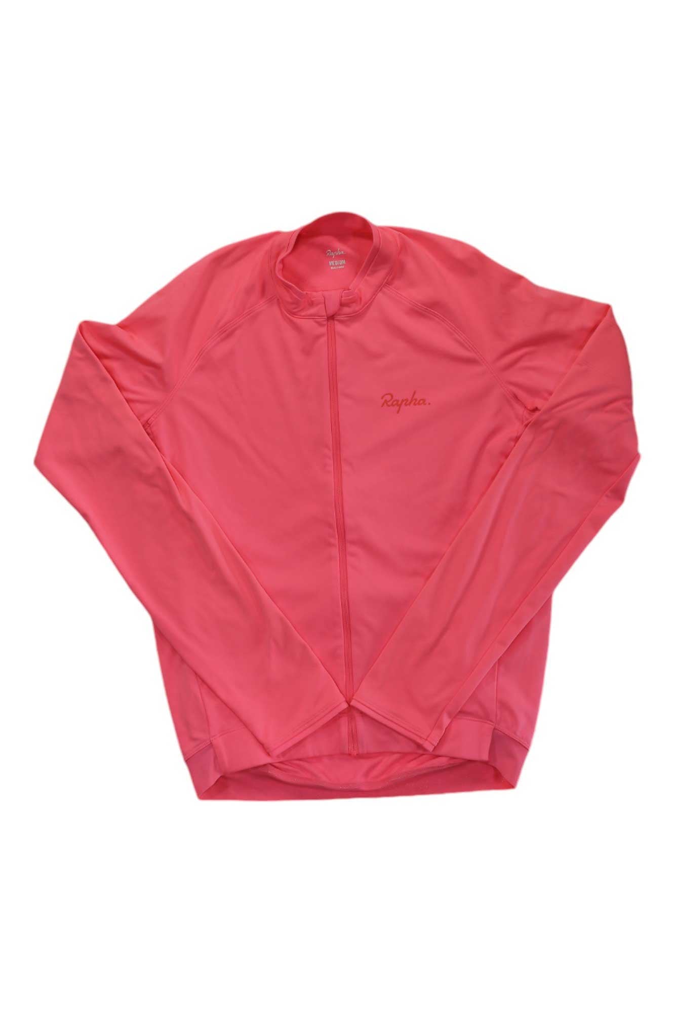 A Rapha Mens Long Sleeve Core Jersey in bright pink, featuring a front zipper and subtle chest branding, is displayed flat on a white background. This cycling jersey offers moisture-wicking performance.