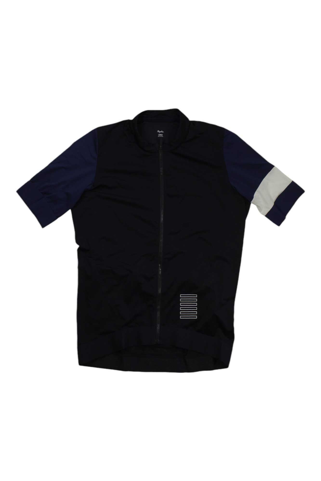 The Rapha Pro Team Training Jersey is a high-performance short-sleeve cycling jersey, mostly black with dark blue sleeves and a white stripe on the left sleeve. A small white-striped patch sits near the bottom right. Front zipper included.
