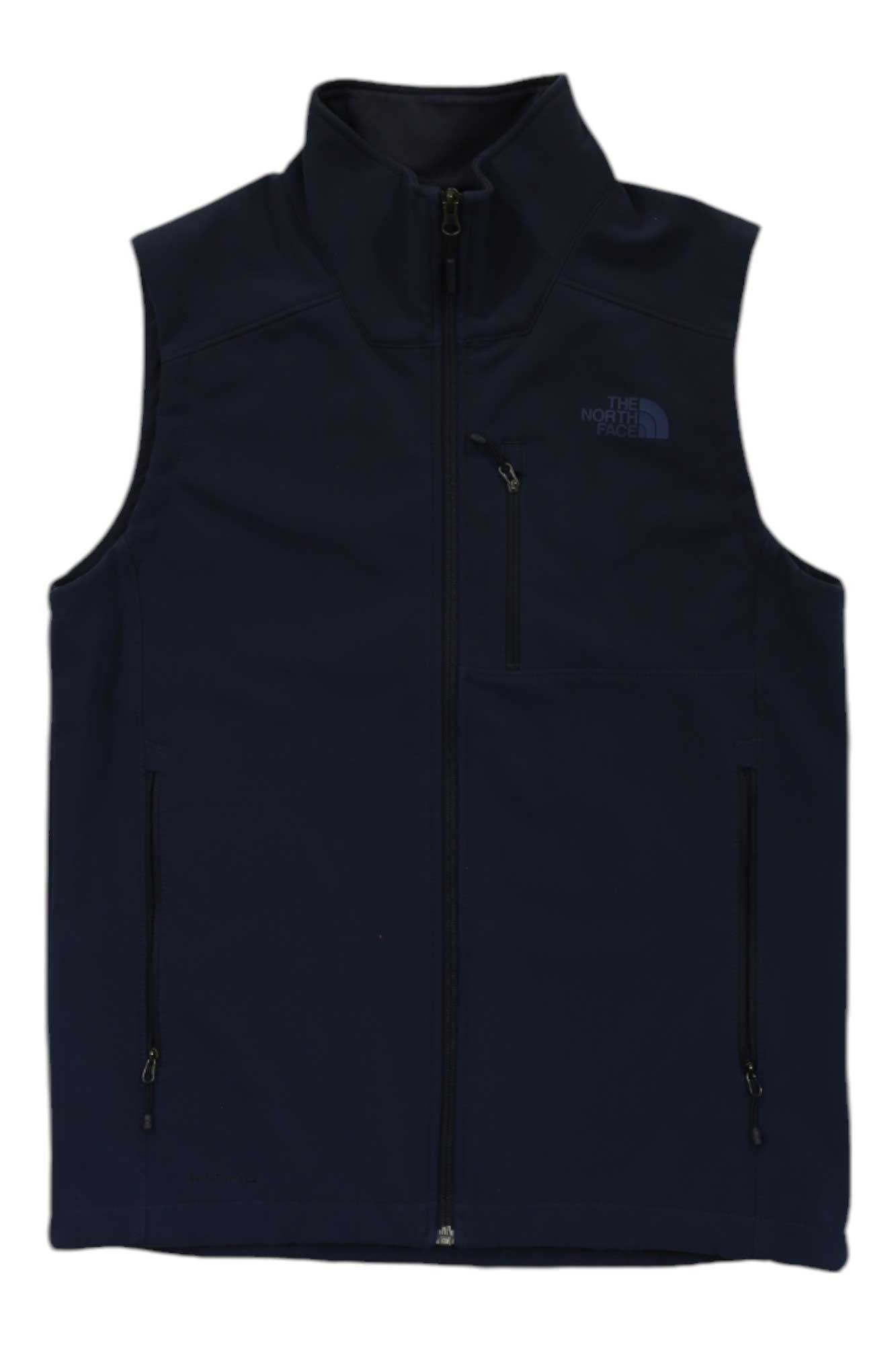 The Mens Apex Bionic 2 Vest is a black, windproof, sleeveless vest with a high collar and The North Face logo on the left chest. It features three zippered pockets—two on the sides and one on the chest—ideal for outdoor activities.