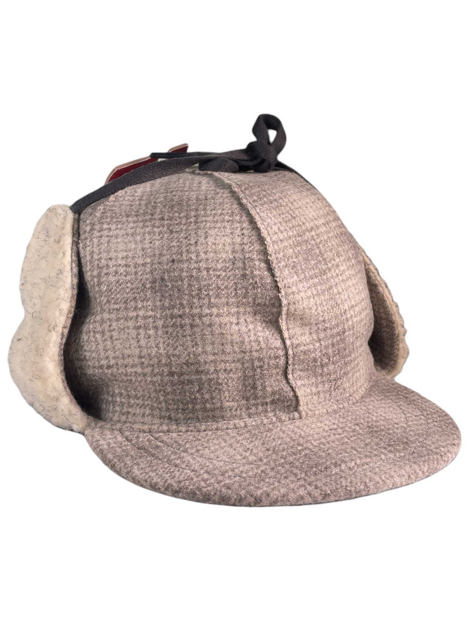 The Stormy Kromer The Snowdrift Cap is a brown tweed men's winter hat with ear flaps and a short front brim, reminiscent of the classic deerstalker made famous by Sherlock Holmes.