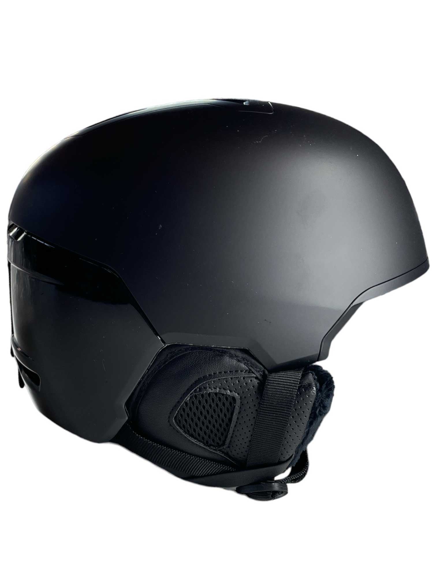 The Julbo Hyperion MIPS Helmet is shown from a side angle against a white background, featuring a sleek matte black finish, rounded shape, padded ear covers, and advanced MIPS safety technology.