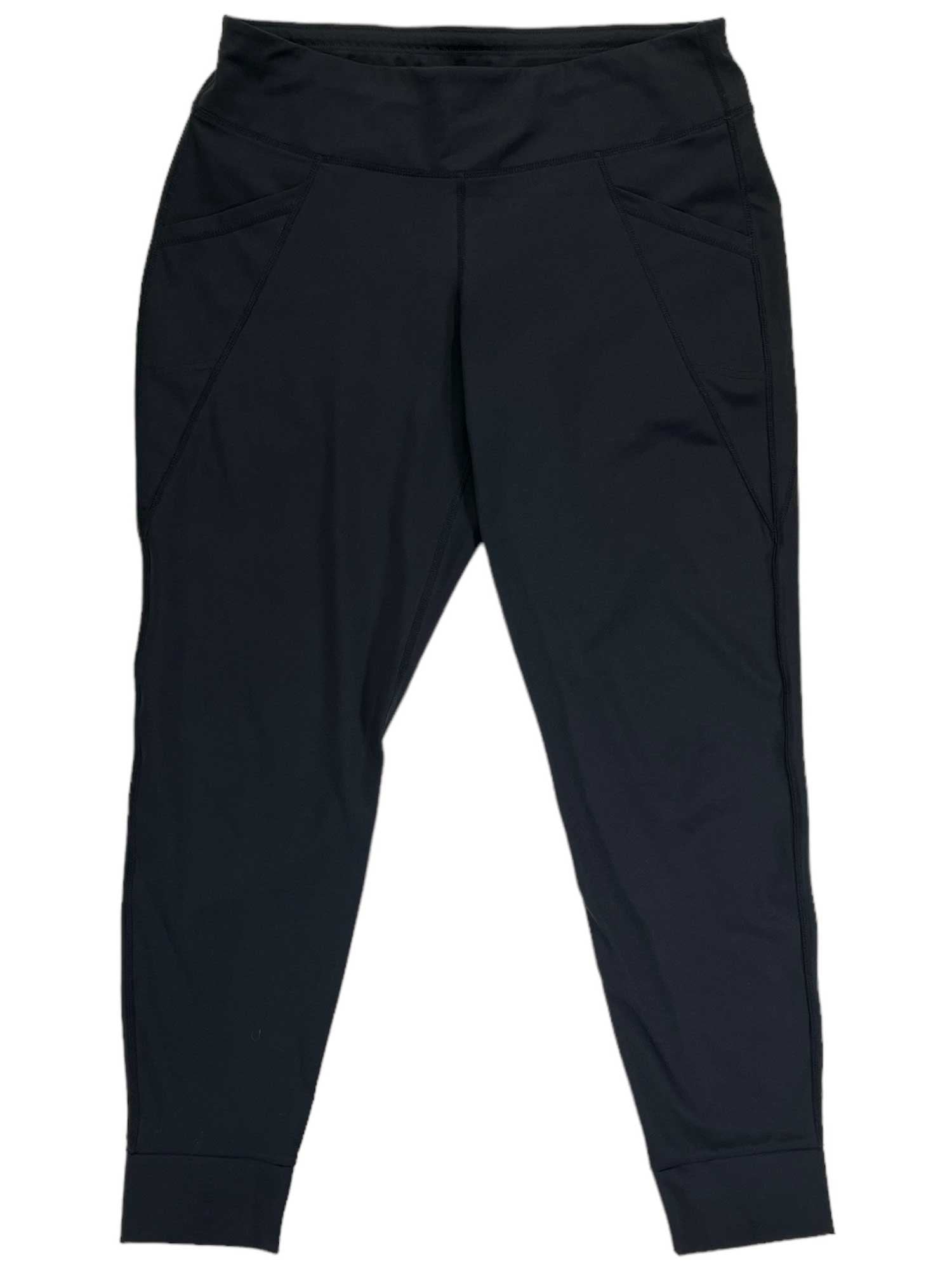 The Transcendr Leggings are black athletic joggers with a high waistband, two side pockets, and visible front seams. Made from durable softshell fabric with a tapered leg design, they offer trail-tough performance and are shown laid flat on a white background.