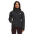 A woman wearing The North Face Womens Belleview Stretch Down Hoodie in black stands with her hands in her pockets, smiling at the camera against a plain white background.