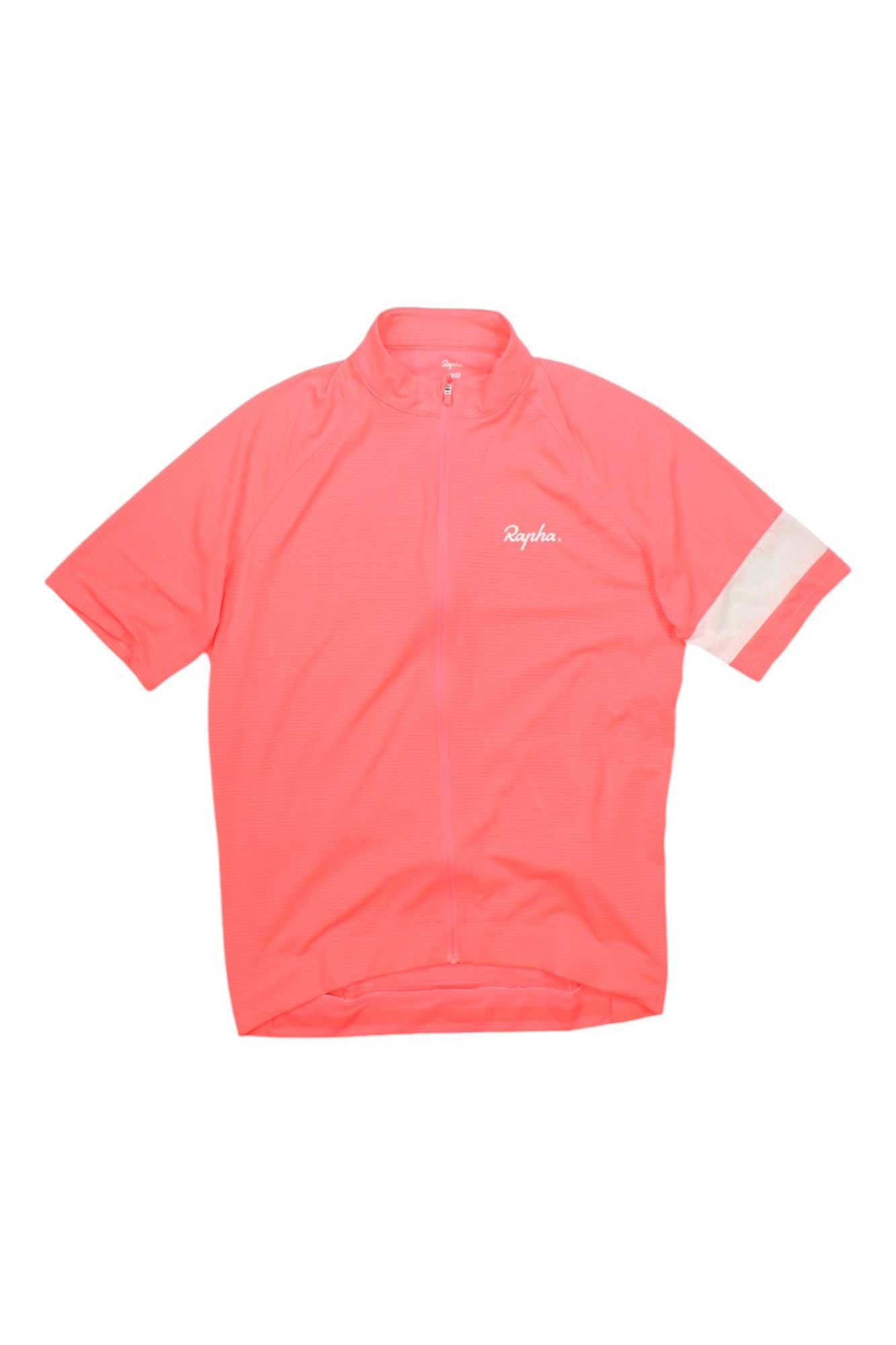 The Rapha Mens Core Lightweight Jersey features a bright pink color, short sleeves, full front zipper, white stripe on the left sleeve, and "Rapha" on the left chest. Lightweight and breathable—ideal for cycling.
