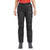 A person wearing Montane Womens Spirit Lite Pant - Reg Leg in black, featuring an elastic waistband and small left thigh logo, paired with a red shirt and gray hiking shoes, stands against a white background.