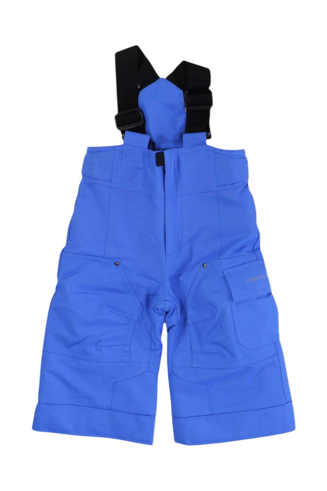 Obermeyer Boys Volt Pant ski pants in bright blue with waterproof fabric, black adjustable suspenders, multiple pockets, and reinforced knees, shown flat on a white background.