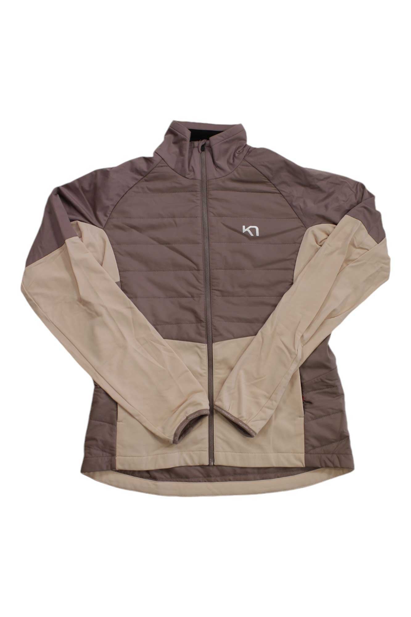 The Kari Traa Women's Ragna Jacket is a stylish, lightweight insulated jacket by Kari Traa, featuring a two-tone design with tan sleeves and lower panels, dark brown upper sections, a front zipper, and a small white logo on the left chest. Crafted from a comfortable wool-modal blend, it offers warmth without sacrificing style.