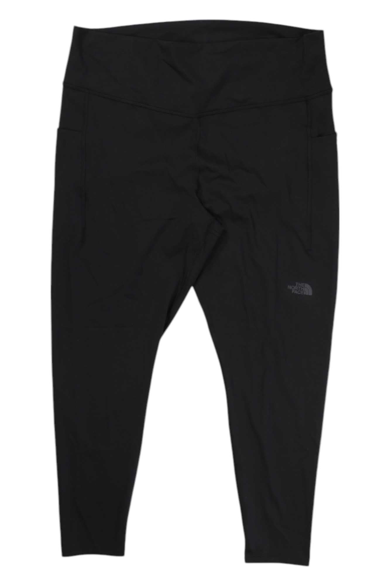 The North Face Womens Motivation High-Rise 7/8 Pocket Tight: black, high-waisted leggings with The North Face logo on the upper left thigh, a smooth finish, and convenient side pockets.