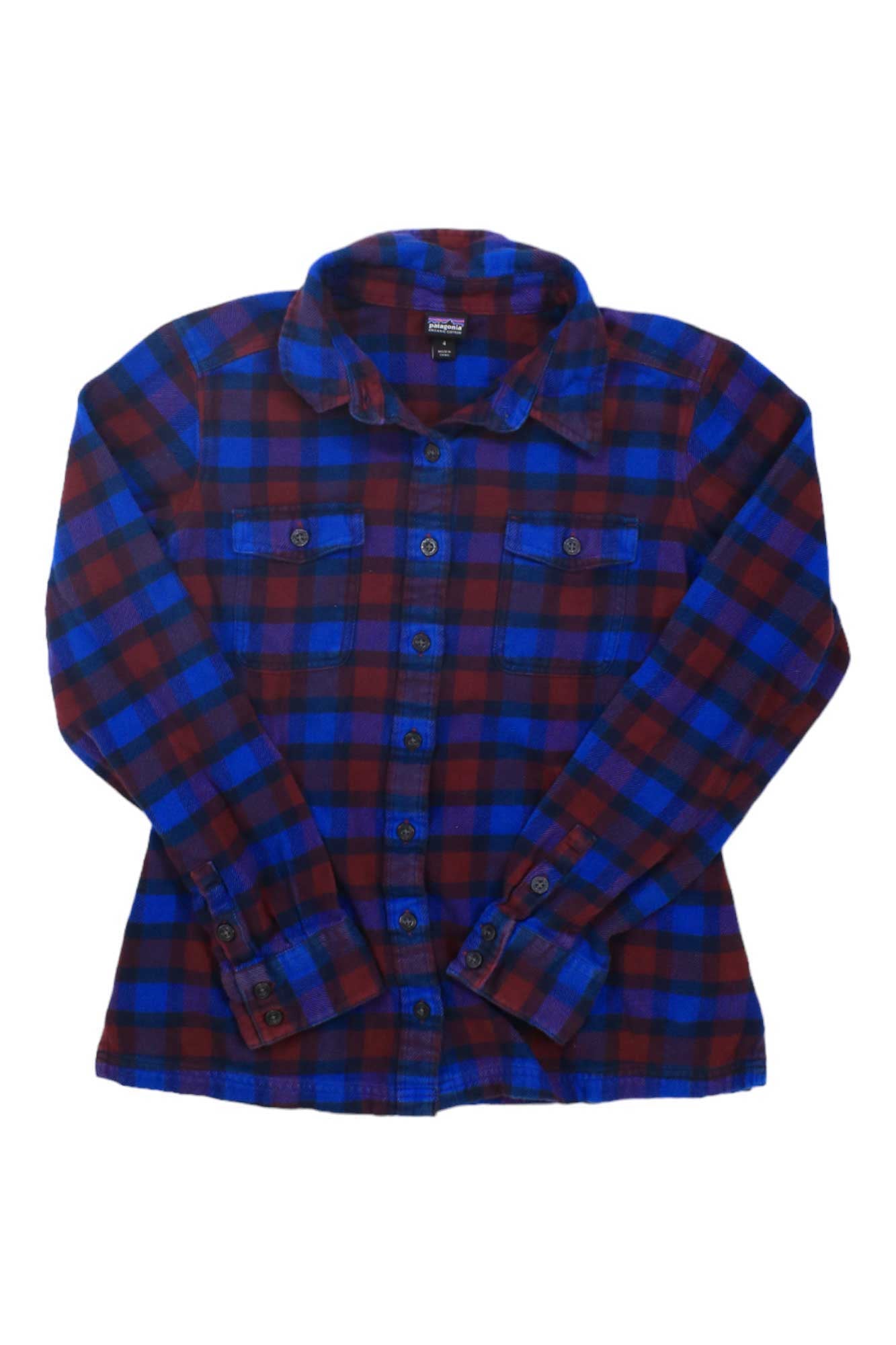 The Patagonia Women's Long-Sleeved Fjord Flannel Shirt is made with organic cotton flannel in a red and blue checkered pattern, featuring two button-flap chest pockets and buttoned cuffs, shown laid flat on a white background.