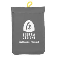 The Sierra Designs Clip Flashlight 2 Footprint is a gray pouch with a yellow loop, featuring the brand's tree-in-arch logo and text. This ground cloth protects your tent.