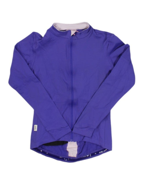 The Rapha Womens Long Sleeve Soupless Jersey in purple features long sleeves, a zip-up front, a light pink interior lining, and a slightly longer back hem, shown laid flat on a white background.