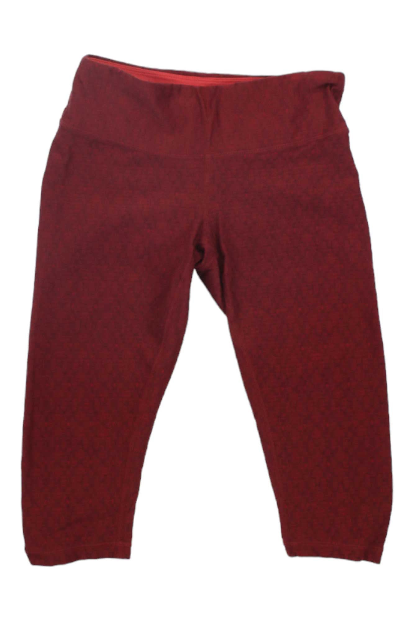 The Prana Womens Misty Knickers in maroon, with a wide waistband and cropped legs, offer moisture-wicking comfort—ideal activewear for hiking or workouts. Shown laid flat on a white background.